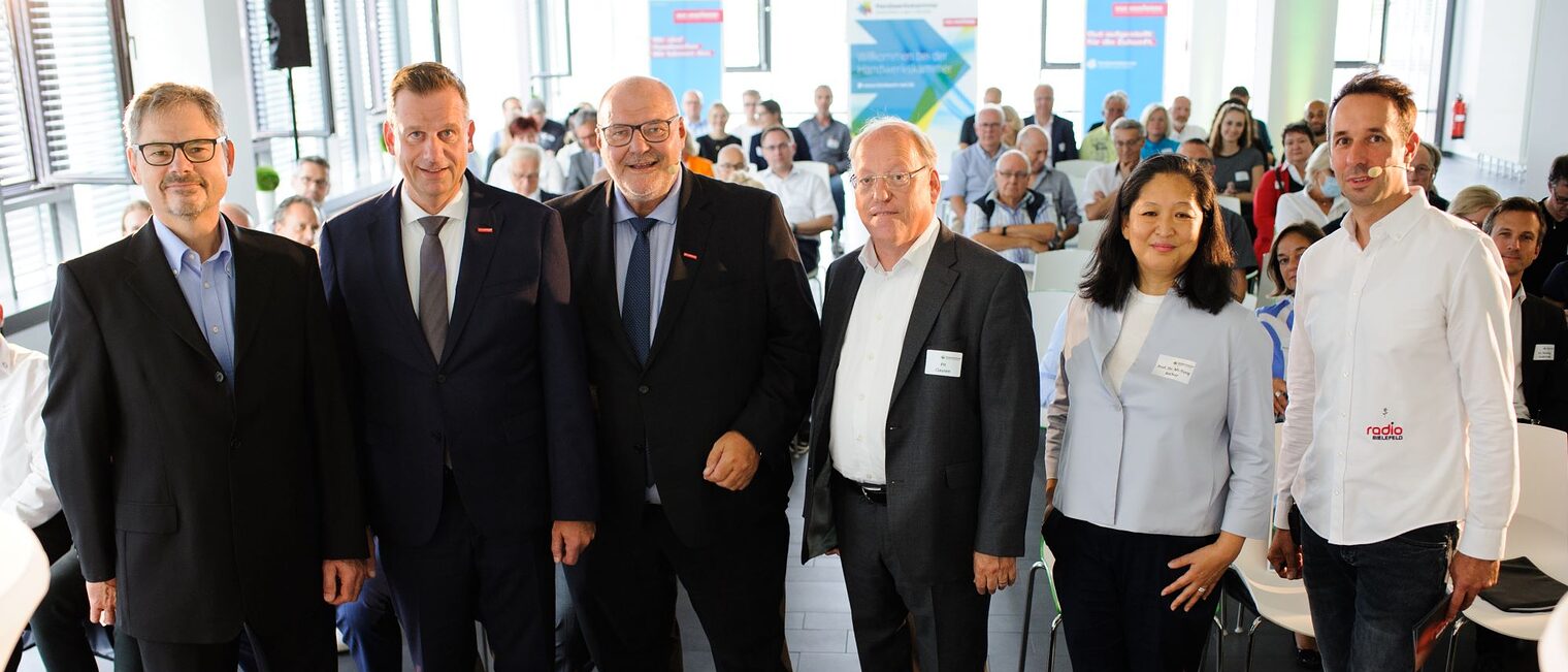 (v. l.) Dr. Christoph von der Heiden, Geschäftsführer der IHK Ostwestfalen zu Bielefeld, Dr. Jens Prager, Hauptgeschäftsführer der Handwerkskammer OWL zu Bielefeld, Peter Eul, Präsident der Handwerkskammer OWL zu Bielefeld, Pit Clausen, Oberbürgermeister der Stadt Bielefeld, Prof. Dr. Mi-Yong Becker, Vizepräsidentin für Nachhaltigkeit, Transfer & Entrepreneurship der Hochschule Bochum, sowie Moderator Timo Fratz, Chefredakteur bei Radio Bielefeld. (v. l.) Dr. Christoph von der Heiden, Geschäftsführer der IHK Ostwestfalen zu Bielefeld, Dr. Jens Prager, Hauptgeschäftsführer der Handwerkskammer OWL zu Bielefeld, Peter Eul, Präsident der Handwerkskammer OWL zu Bielefeld, Pit Clausen, Oberbürgermeister der Stadt Bielefeld, Prof. Dr. Mi-Yong Becker, Vizepräsidentin für Nachhaltigkeit, Transfer & Entrepreneurship der Hochschule Bochum, sowie Moderator Timo Fratz, Chefredakteur bei Radio Bielefeld.