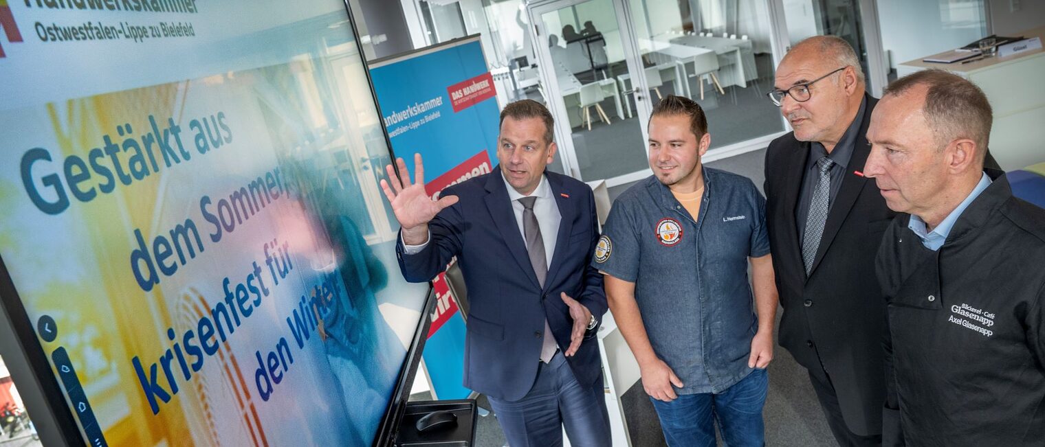 Unter dem Motto "Gestärkt aus dem Sommer, krisenfest für den Winter?" stellen (v. l.) Dr. Jens Prager, Hauptgeschäftsführer der Handwerkskammer OWL, Fleischermeister Lennart Hermstein (Fleischerei Münch), Kammerpräsident Peter Eul sowie Bäckermeister Axel Glasenapp, Obermeister der Bäcker-Innung Gütersloh, die derzeitige konjunkturelle Situation im OWL-Handwerk vor. 