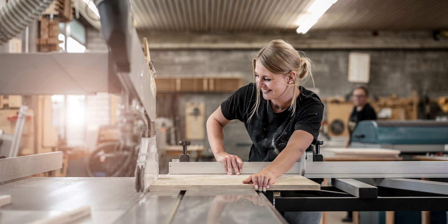 Frau arbeitet an der Werkbank.