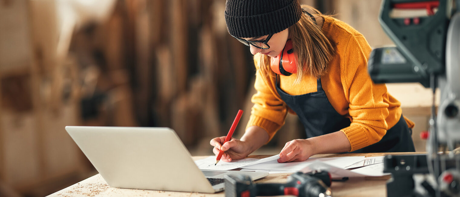 Artisan woman working in carpentry workshop